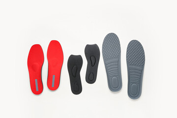 Many orthopedic insoles on white background