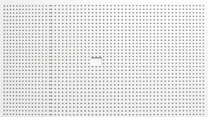 A white surface covered in evenly spaced holes with a small square cut out in the middle section