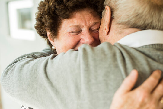 Hugging senior couple