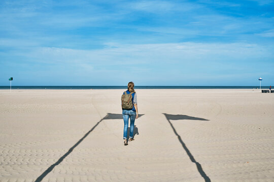 Tourist walking on sand at beach
