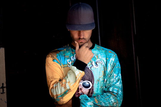 Stylish young man wearing basecap and printed shirt