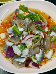 Spicy clupeidae Thai fresh fish salad with Leucaena leucocephala and cucumber.
