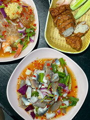 Spicy clupeidae Thai fresh fish salad with Leucaena leucocephala and cucumber.
