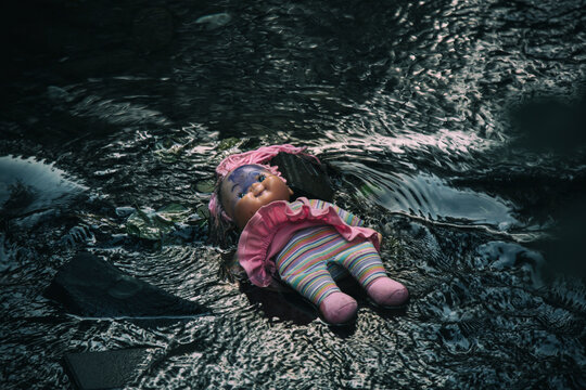 Doll lying in brook