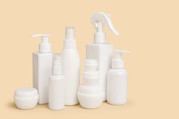 Composition with jars and bottles of cosmetic products on beige background