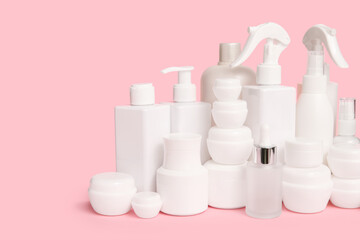 Different cosmetic products on pink  background