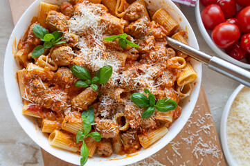 Pasta with delicious fried sausage balls in tomato sauce with parmesan cheese