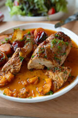Braised chicken breast with vegetables and sauce on a plate. Delicious healthy and low fat dinner. Protein rich