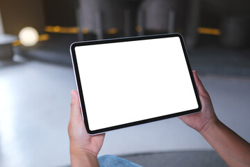 Mockup image of a woman holding digital tablet with blank white desktop screen