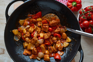 Traditional chicken sweet sour in a wok 