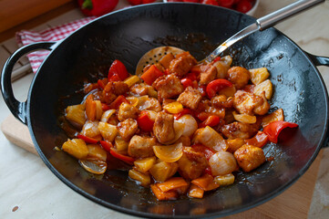 Traditional chicken sweet sour in a wok 
