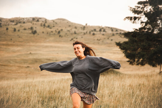 Cheerful woman running in Durmitor National Park