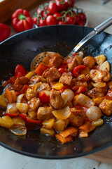 Traditional chicken sweet sour in a wok 