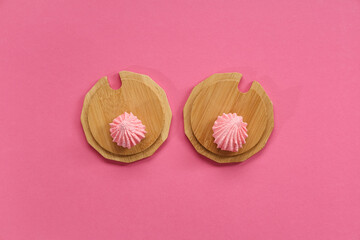 Wooden drink coasters with sweet cookies on color background. Erotic and female health care concept
