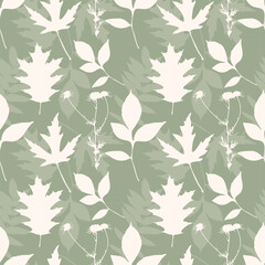 Green textile pattern. Autumn Vibe. Soft pattern with beige leaves silhouettes. Herbarium.