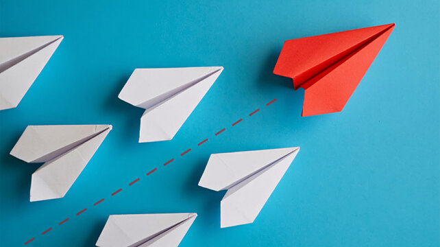 Stand out from the crowd with a red paper airplane leading the way to business success and innovation