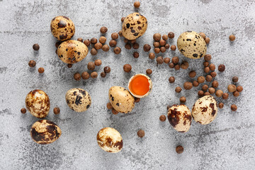 Raw quail eggs and allspice on grunge background
