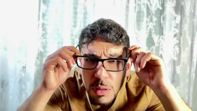 Man wearing glasses with uncertain expression on white background