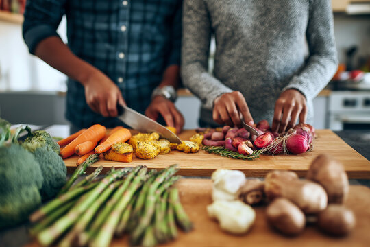 Couple cooking vegan Thanksgiving dishes together, roasted vegetables and plant-based alternatives, modern lifestyle kitchen,