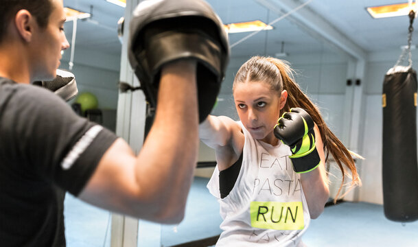 Young woman in gym doing boxing training