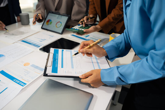 business team working on a project in the office or reviewing and discussing a business project.