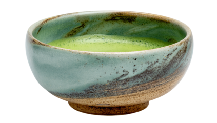 A small, round, light teal and brown ceramic bowl filled with frothy green matcha