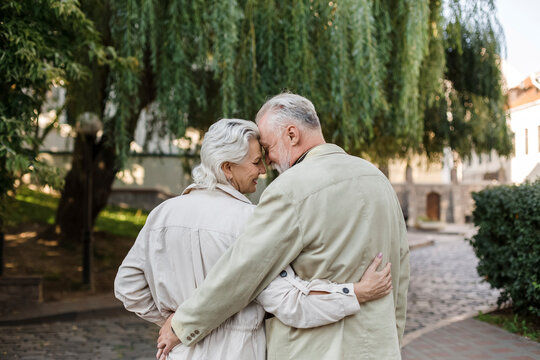 Couple with arms around embracing each other