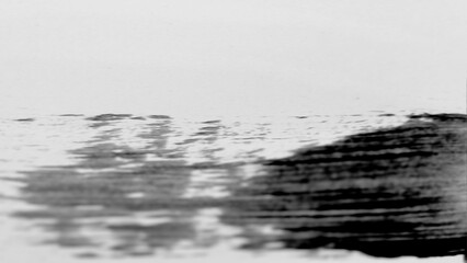 Motion blur horizontal black and white ink. Stroke is a sharp, jagged line that defines boundary between dark paint and white space. Below this line paint gray and dark black strokes