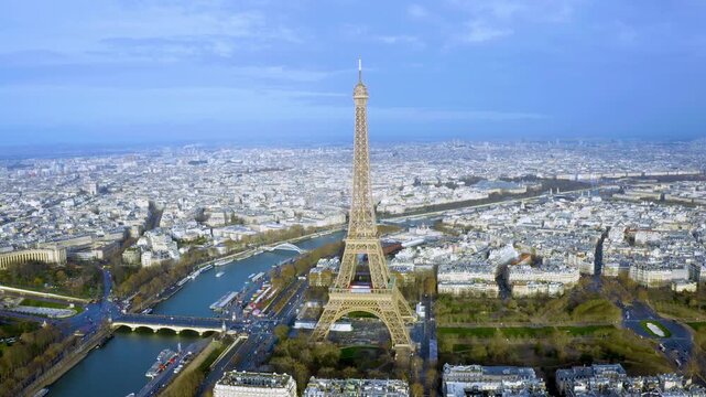 4K drone panorama of Paris with the Eiffel Tower towering above the Seine, Champ de Mars and Trocad&eacute;ro - crisp daylight cityscape highlighting iconic French architecture and bridges.