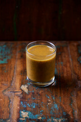 Mango smoothie on wooden background. Soft focus. Copy space.	