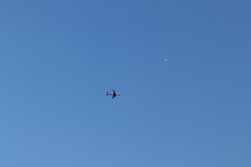 Two Airplanes Flying at Different Altitudes in Clear Blue Sky
