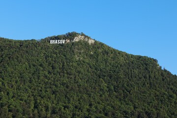 Panoramic View of the Brasov Sign on Tampa Mountain under a Clear Blue Sky