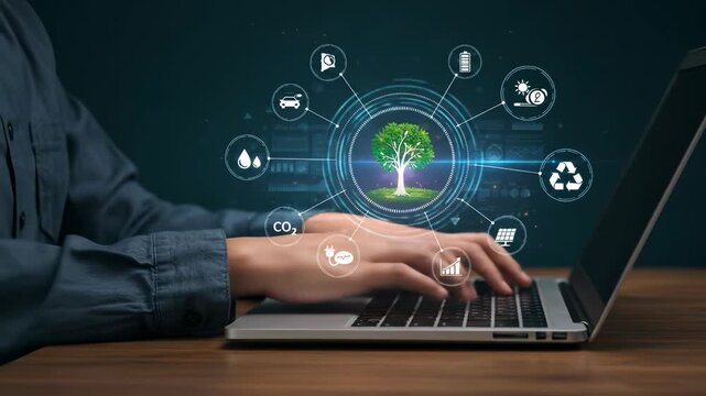 Sustainable Technology Solutions: Person Typing on Laptop with Green Energy and Environmental Protection Icons &ndash; Renewable Energy, CO2 Reduction, Recycling, and Eco-Friendly Development Concept