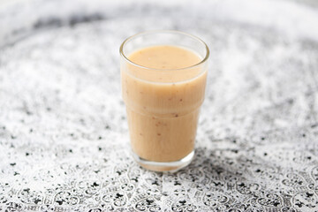 Pineapple coconut smoothie on bright background. Soft focus. Copy space.
