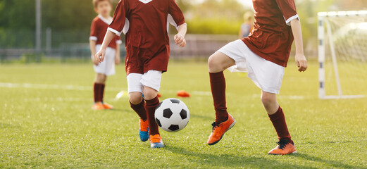 Youth Soccer Match – Kids Playing Football on Grass Field, Practicing Teamwork, Dribbling and Ball Control During Game © matimix