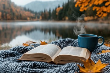 Cozy Autumn Reading by the Lake with Hot Beverage and Leaves
