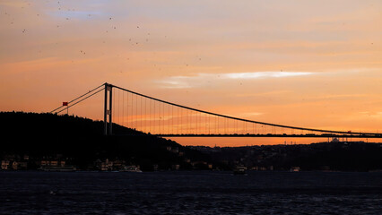 Obraz premium Panorama of cable-stayed bridge across Bosphorus. Istanbul, orange sunset sea