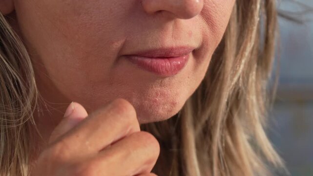 Woman eating ice cream, close-up on mouth enjoying sweet treat outdoors