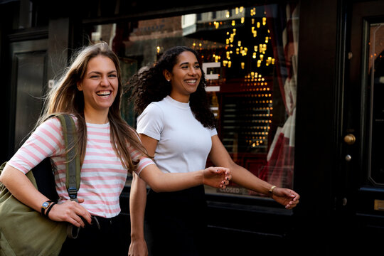 Two girlfriends on a city break, going on a shopping spree