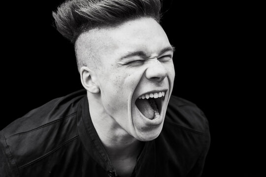 Black and white portrait of young man screaming
