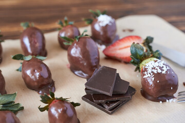 Chocolate dipped strawberries on a wooden board. Selective focus.