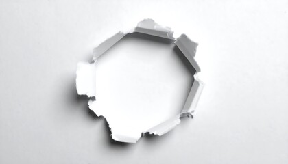 A precisely torn, regular hexagonal hole pierces a plain white surface, showcasing a contrasting void.