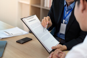 Business Insurance Consultation with Client Discussing Policy Details