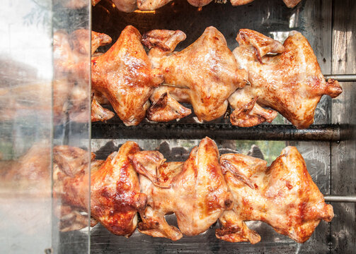 Chickens roasting on a grill