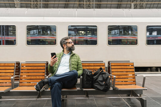 Man sitting on a bench at the train station