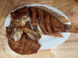 dried fish on wooden board