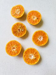 Halved Tangerines on a White Background 