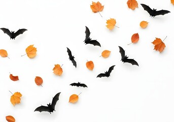 Fototapeta premium Halloween bats and autumn leaves arranged on white background, creative holiday season design