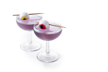 Purple Halloween cocktail garnished with candy eye isolated on white background