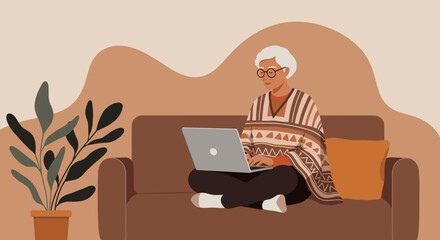 Elderly person comfortably using a laptop on a couch at home, highlighting modern senior living, digital literacy, and remote connectivity.